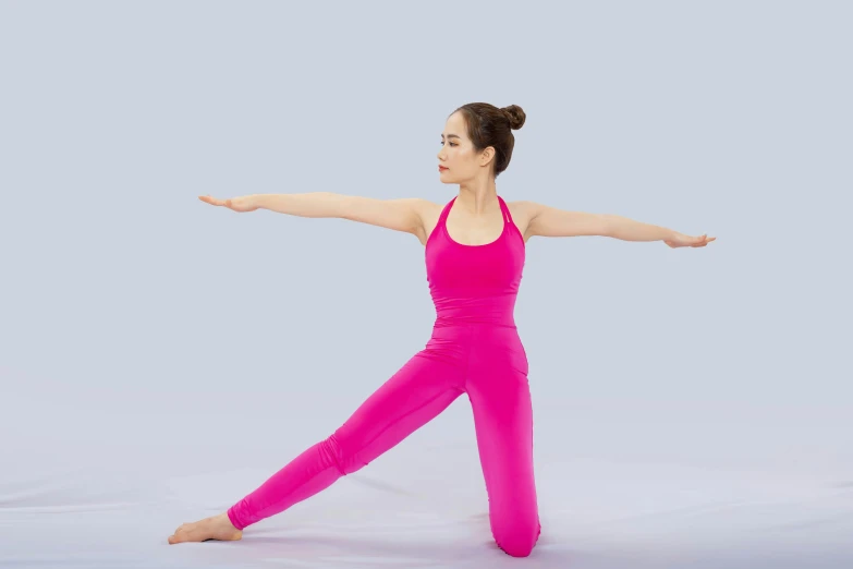 woman in pink practicing yoga poses and reaching out