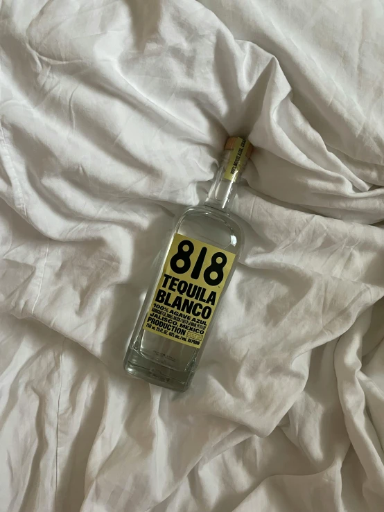 an empty bottle that has been placed on some sheets