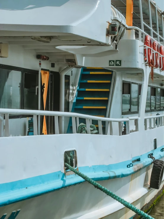 an old white boat docked near a dock