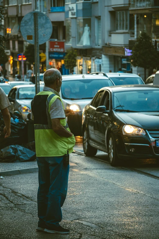 a man standing on the side of the road holding a backpack