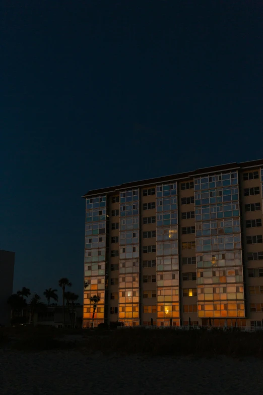 a group of buildings sitting in front of a large moon