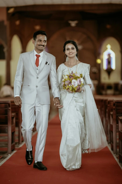 a man and a woman holding hands in front of a church