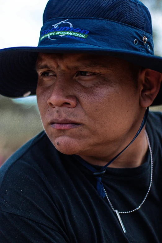 a man with a blue hat looking away