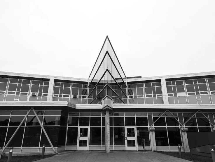 a modern building in the snow with a triangular design on the facade