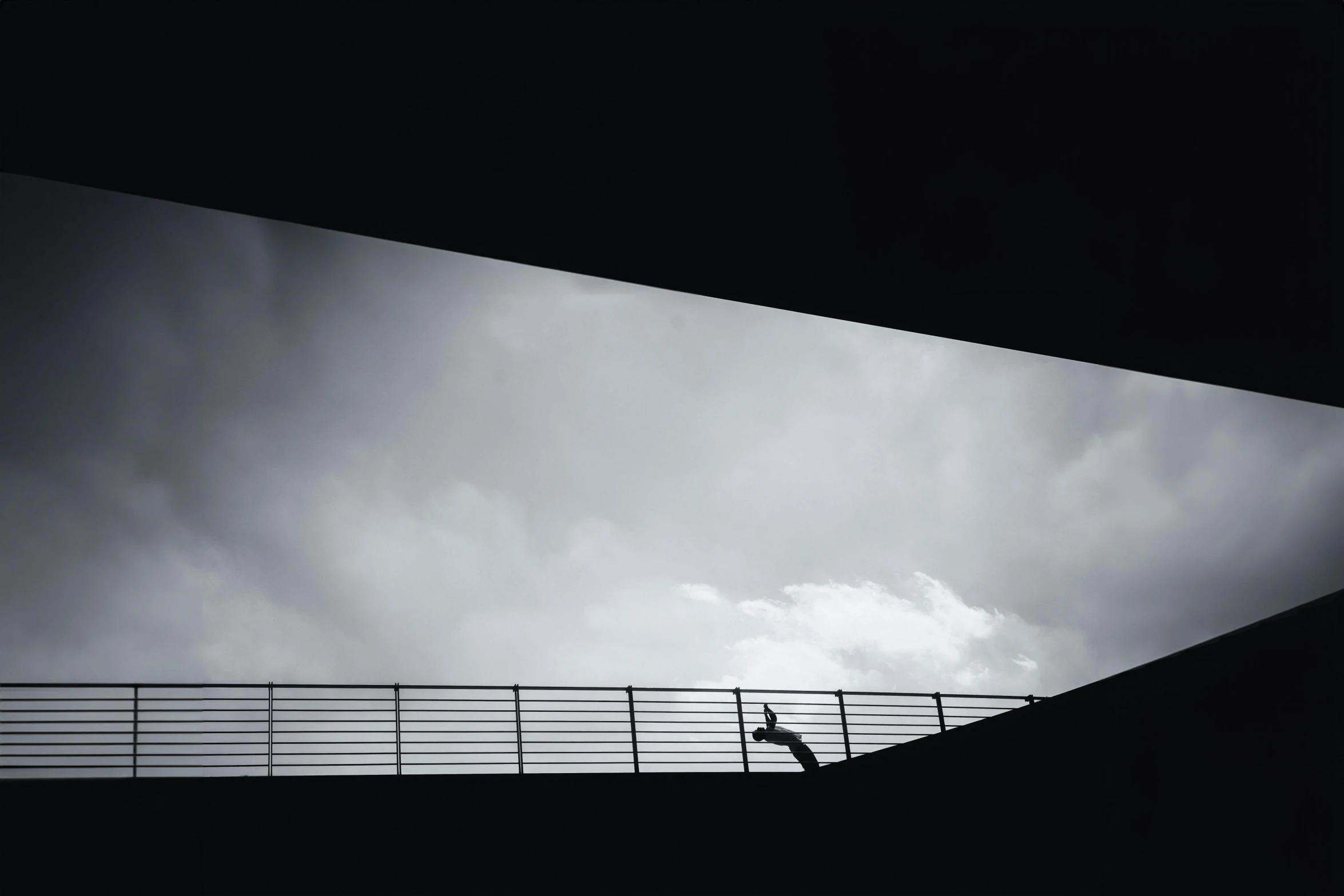 the bridge has a man on it while it is dark