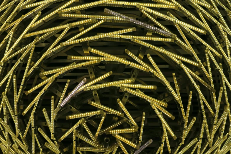 many strands of yellow colored metal wire on top of each other