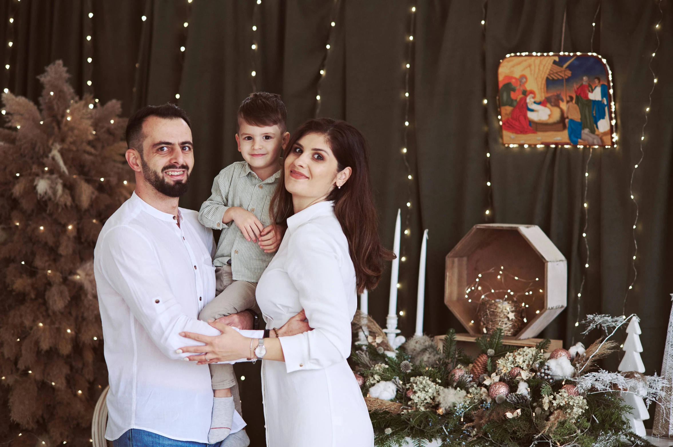 a family in front of their christmas backdrop