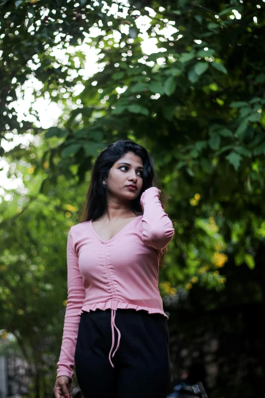 a young woman poses for the camera while wearing black sweat pants