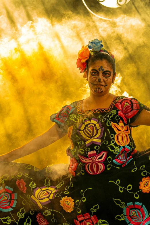 a woman wearing a colorful dress in front of yellow light