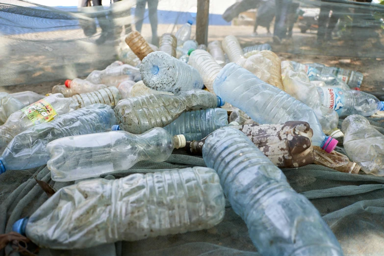 plastic bottles with their lids down and used on the ground