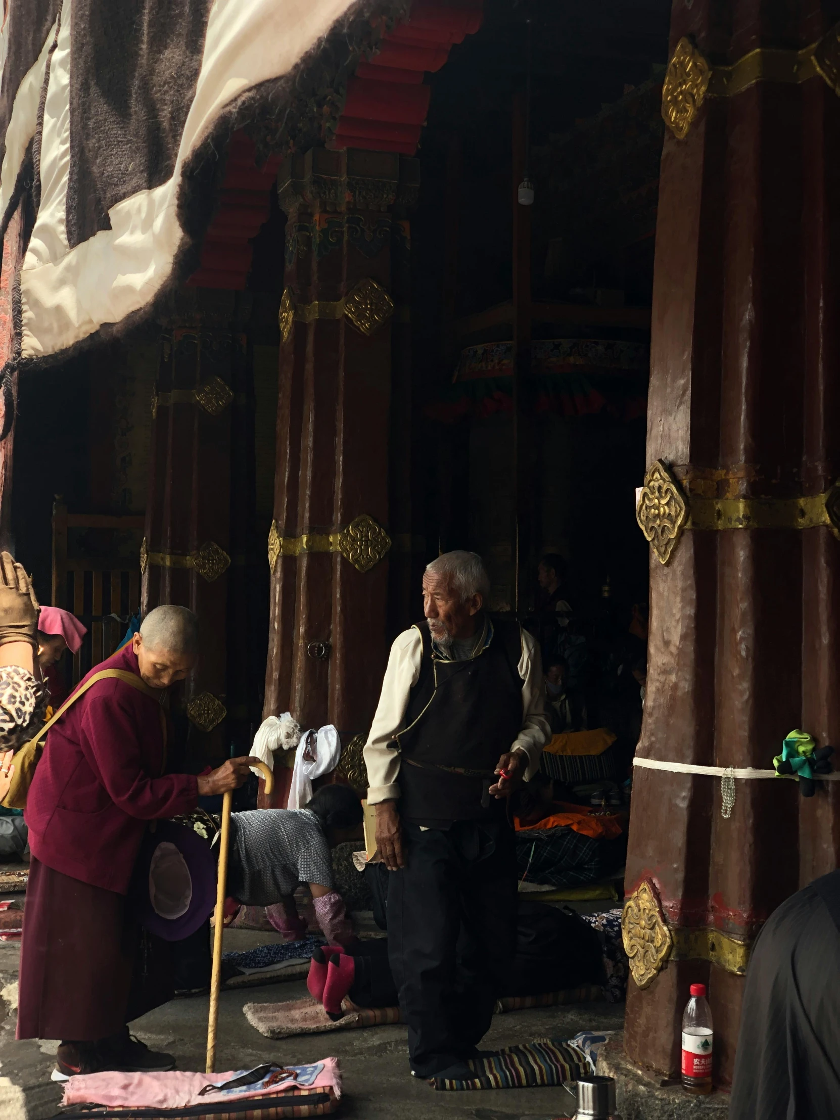 a couple of monks standing by some tents