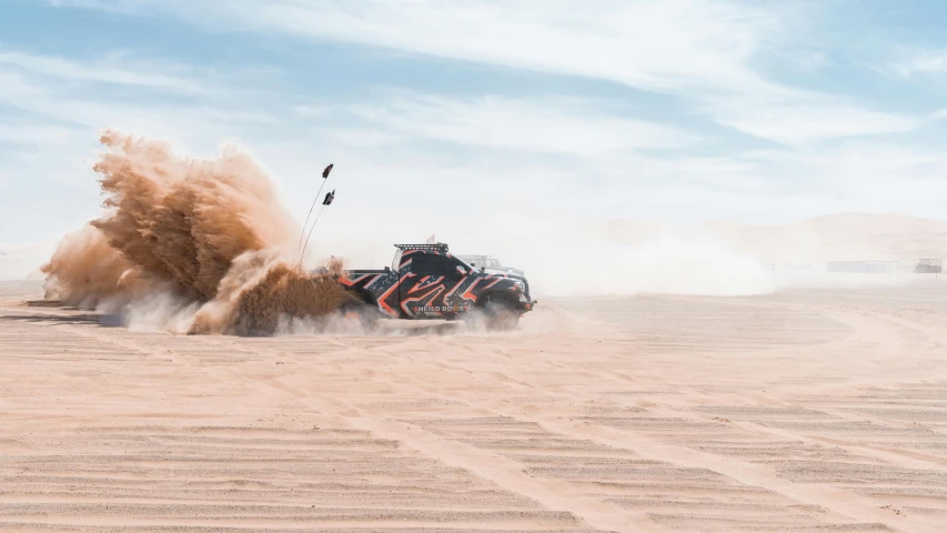 an suv is driving down a dusty road