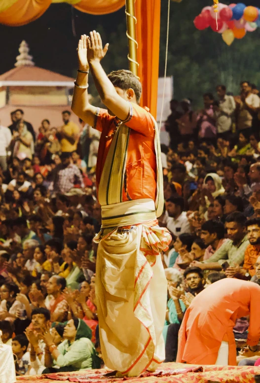 the man is doing handstand at the event