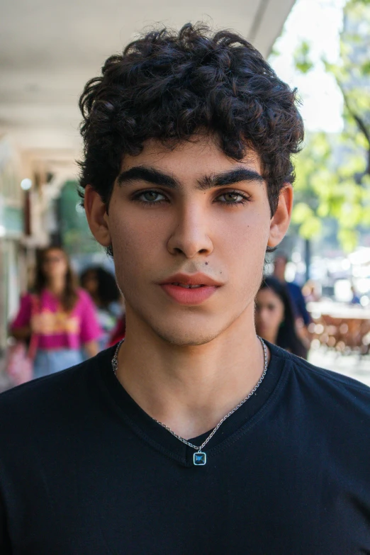 a man in a black shirt looks away from the camera