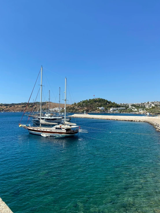 several boats parked on a beach by the shore