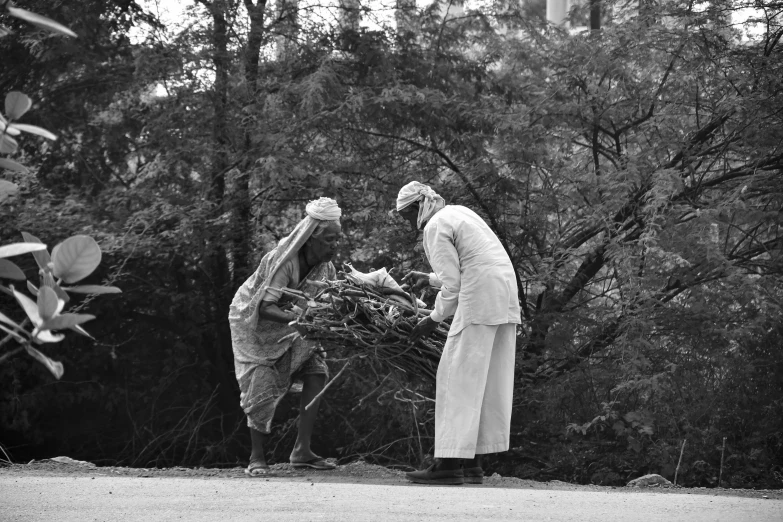 a priest and a woman holding twigs