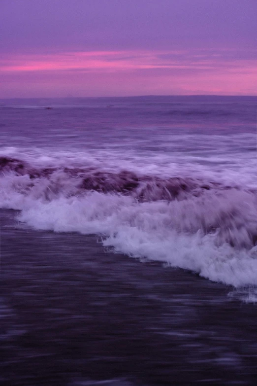 a pink and purple sunset on the ocean