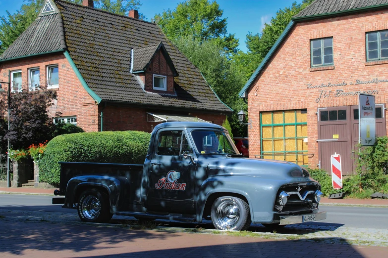 a shiny gray truck parked in front of a house