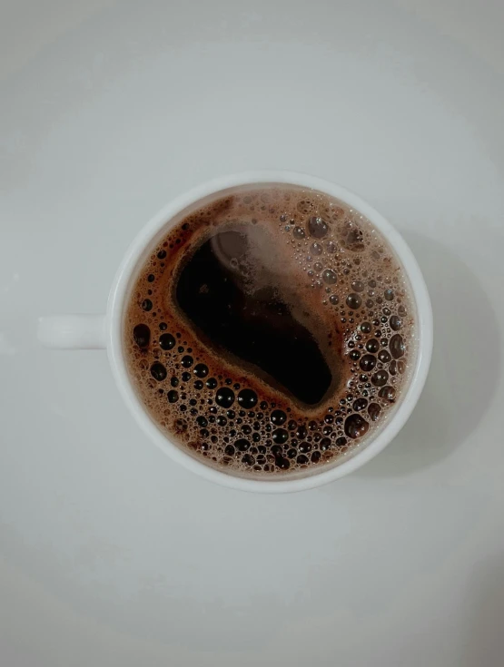 a cup with some liquid on it sitting on a table