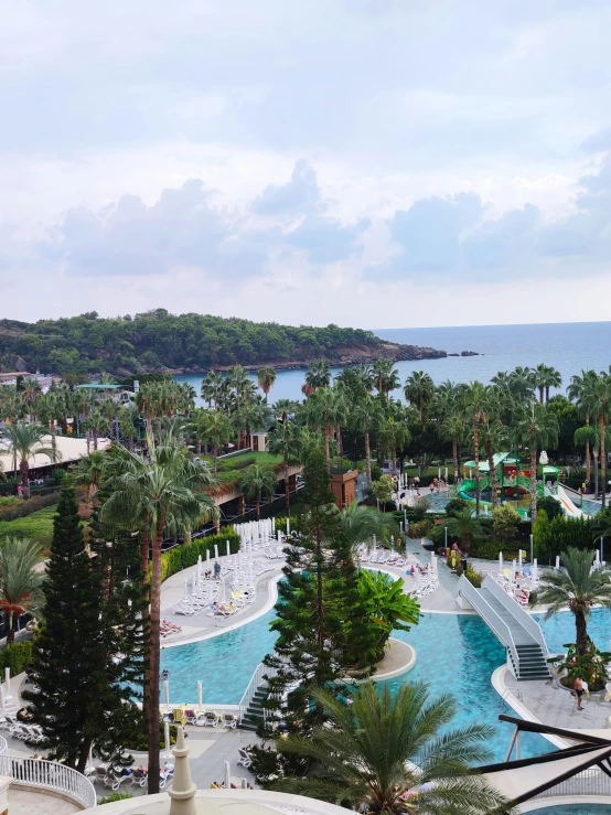 a large swimming pool that has a slide near the edge