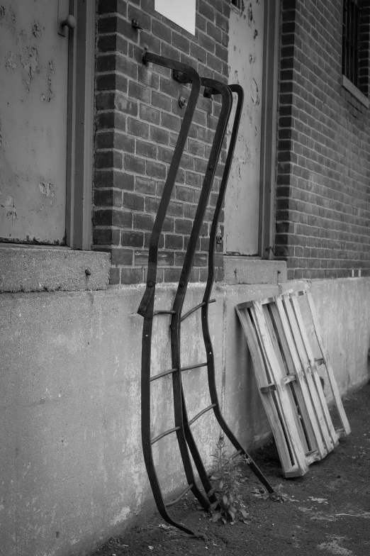 the long metal ladders have been leaning against the building
