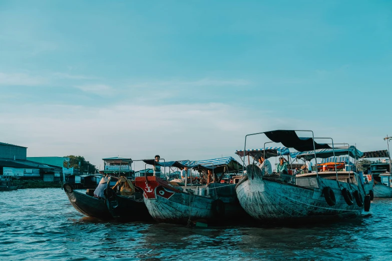 some very old and very long boats in the water