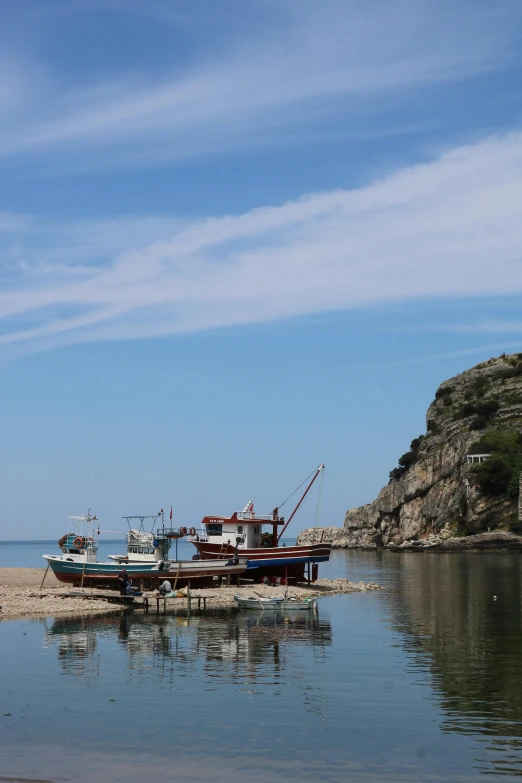 a boat parked in the water on top of a small island