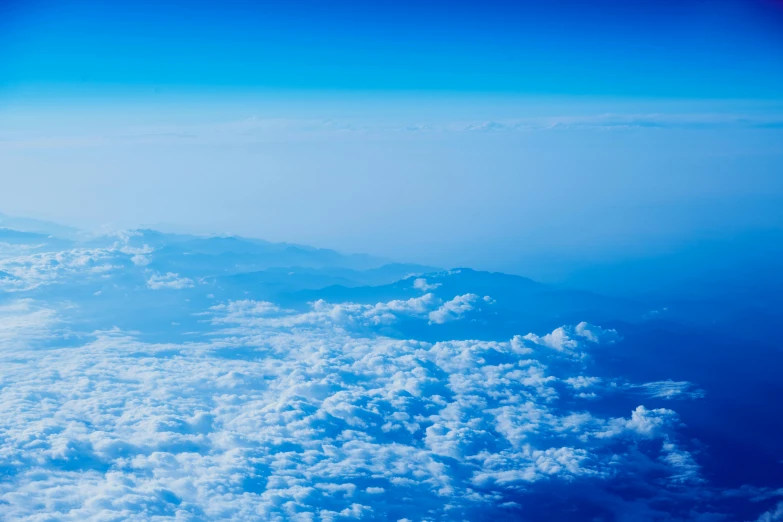 the blue and white clouds are from an airplane window