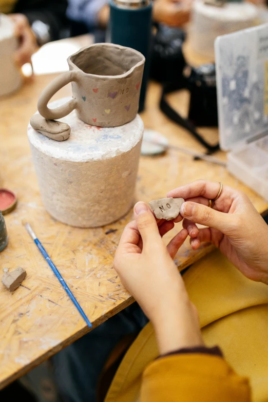 a close up of a person working on pottery