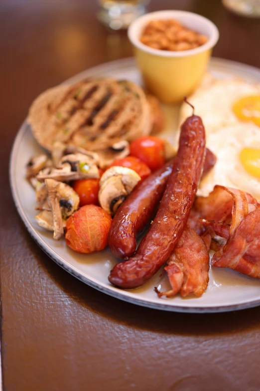 a plate full of breakfast foods and a small bowl of food