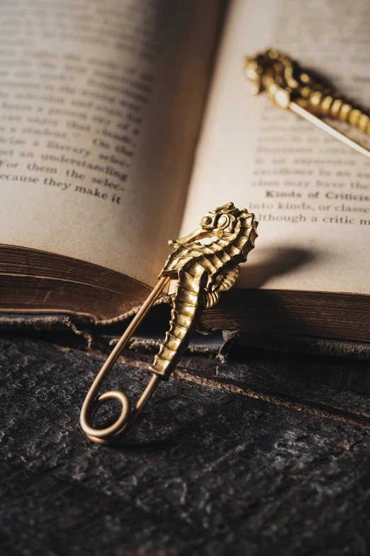 an open book with a golden pen sitting on top