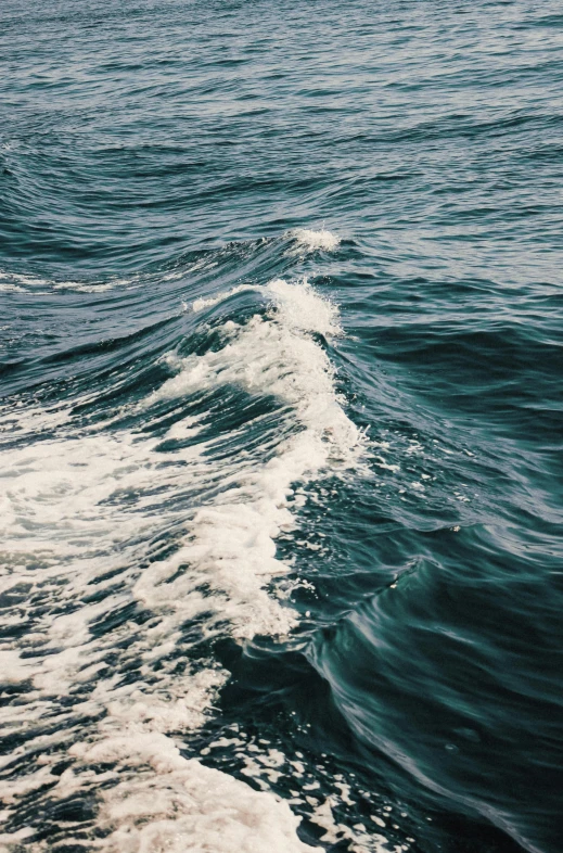 a large body of water with waves in the distance