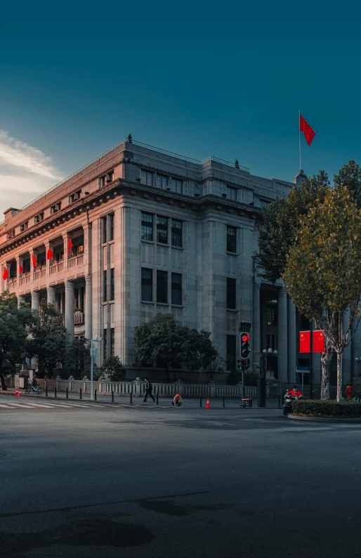 a big building next to some trees on the street