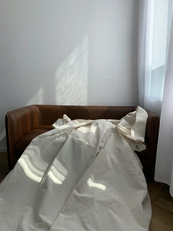 the sheet on a couch is covering it