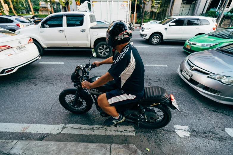 a man is on a motorcycle in the middle of a street