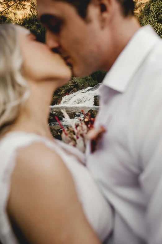 man and woman kissing while holding each other