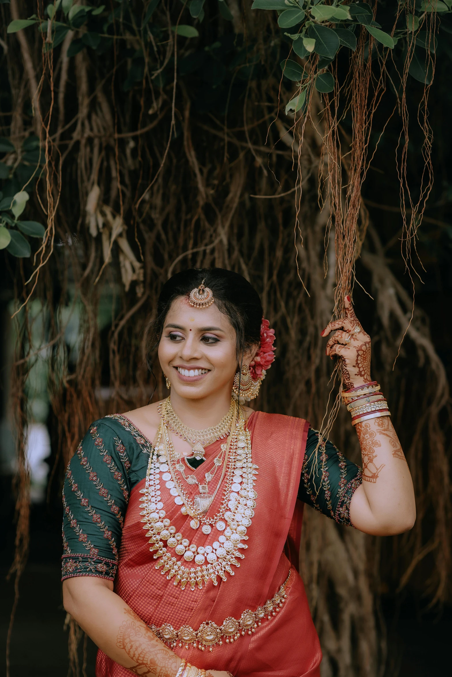 the woman is smiling and wearing an ethnic indian outfit