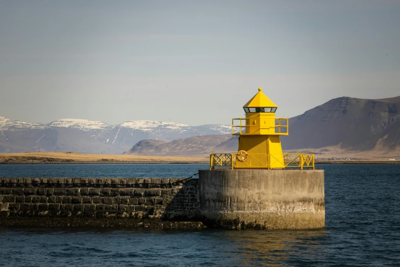 there is a lighthouse at the edge of a body of water