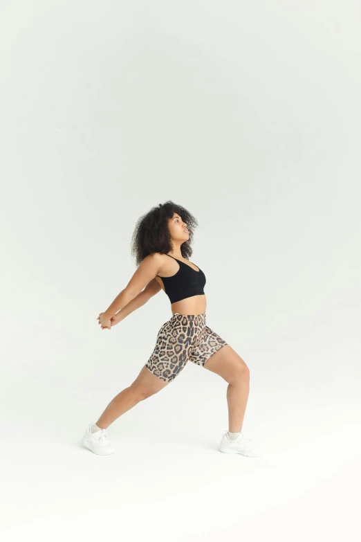 a woman in leopard print leggings and black sports  top