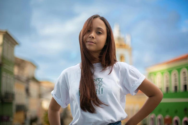 a beautiful young lady standing in front of a building