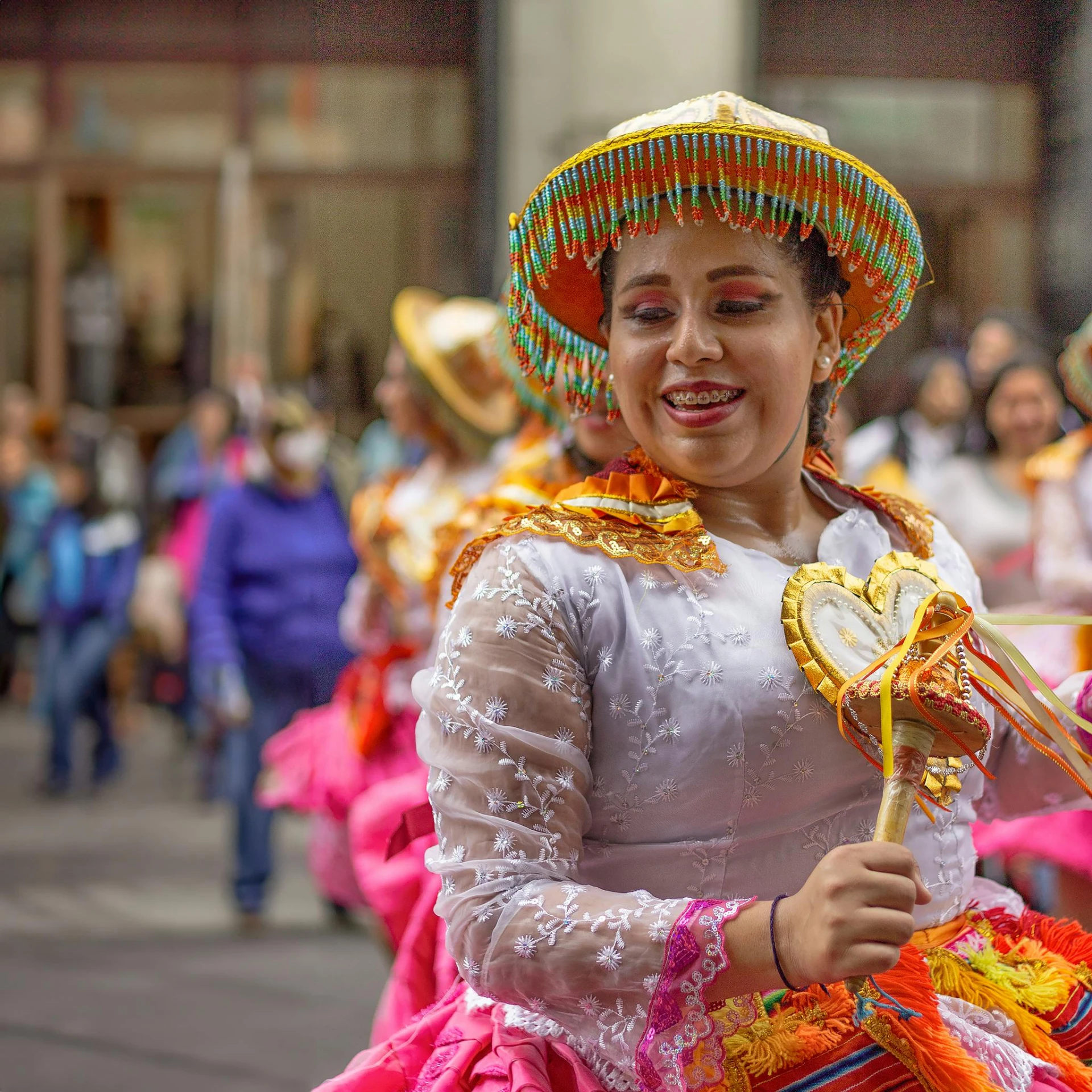 a woman with many colorful outfits and large fans