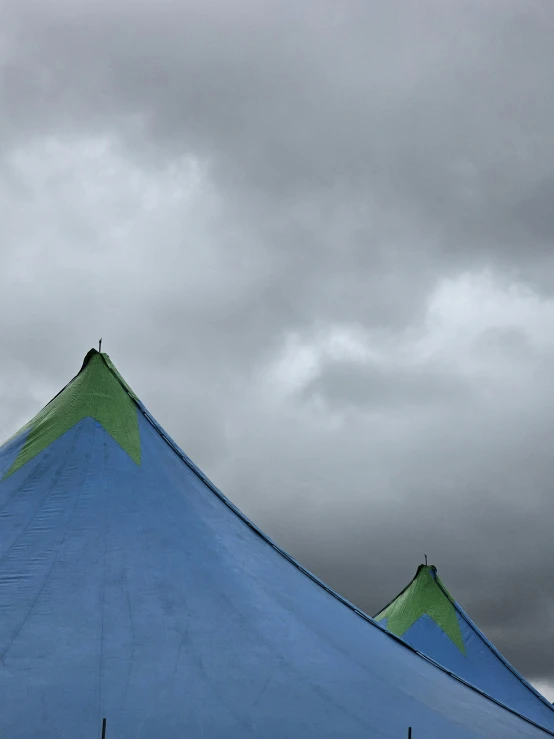 a big blue tent with a sky background