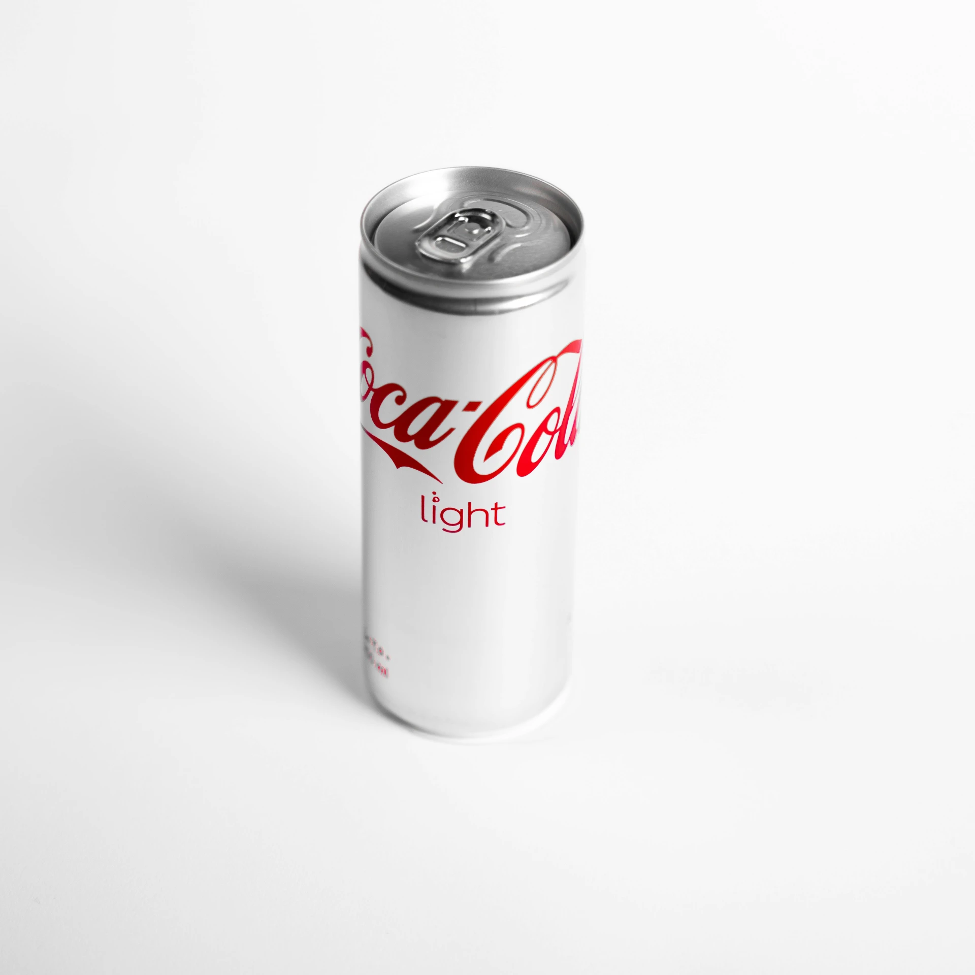 a can of light coke on a white background