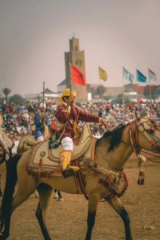 man riding on a horse in a crowd