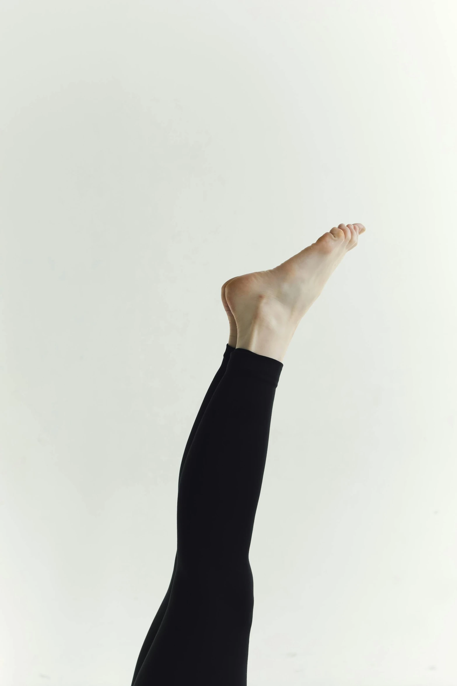 a person stretches their arms up and toes down