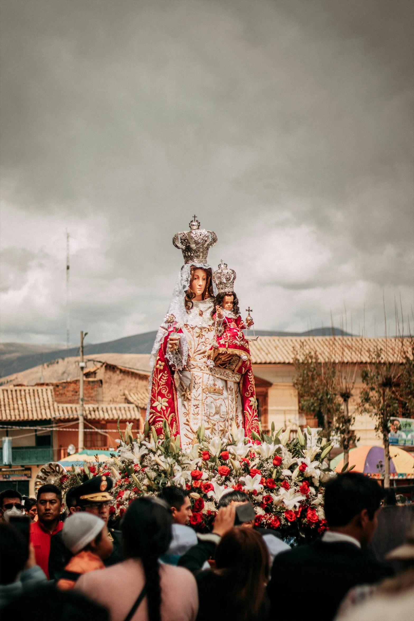 a statue with two women in it in the middle of a crowd