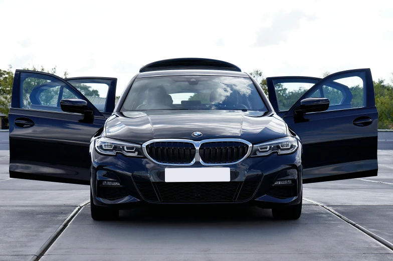 a modern looking bmw vehicle is seen next to a large suv
