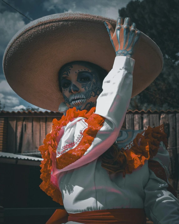 a woman in skeleton makeup in a mexican outfit