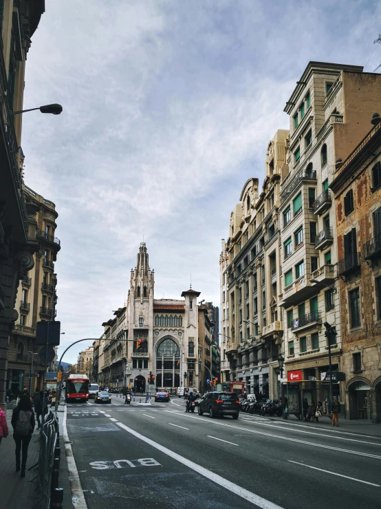 a city street lined with tall buildings next to a tall building