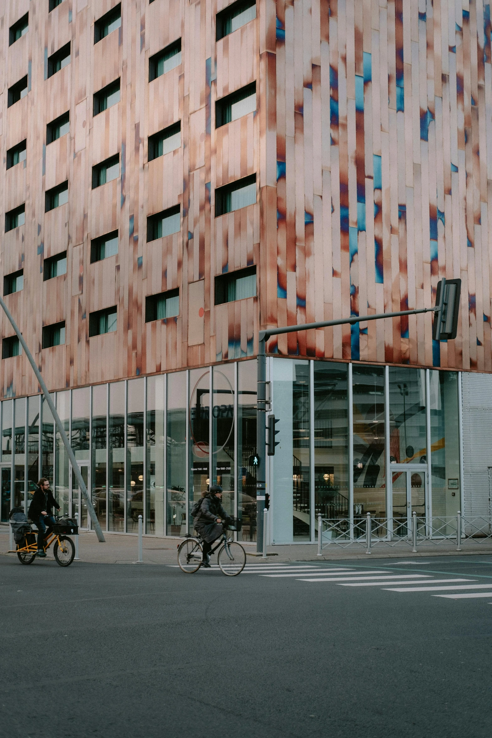 a group of people riding bikes on a city street